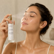 Misting L'Eau Rosée onto the face